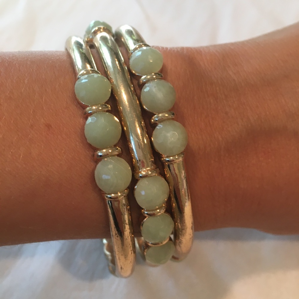 Set of 3 bangles. Gold with light blue stones.